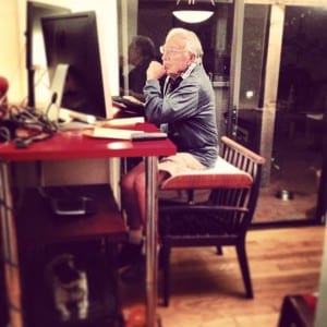 Here's my dad two years ago using his old computer at my standing desk. Pretty clever. He hacked my standing desk using a chair and an ottoman.